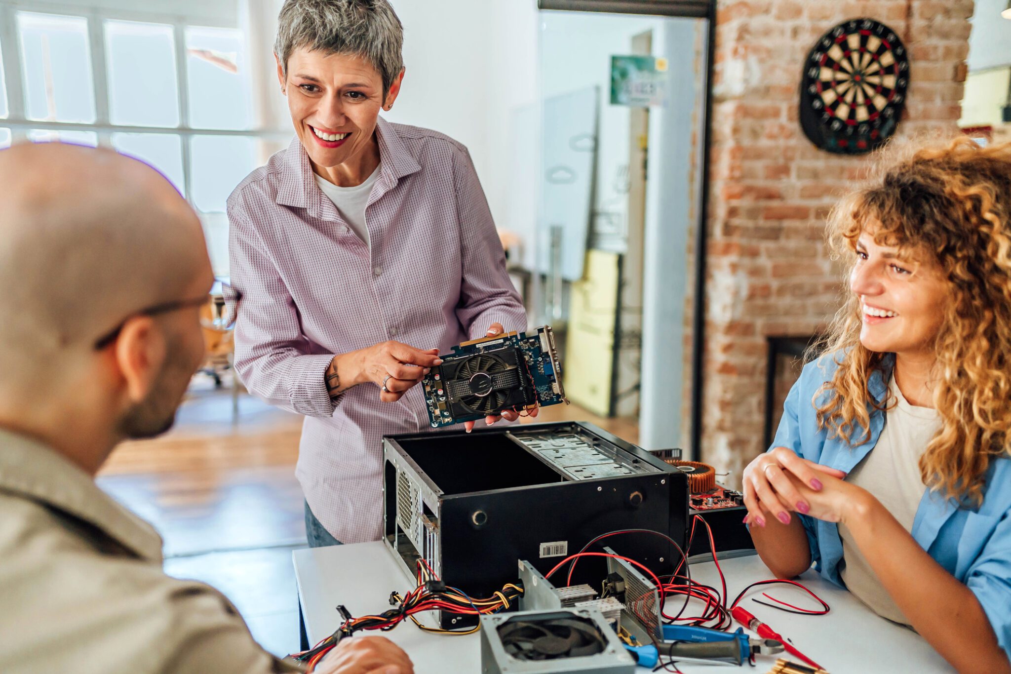 People discussing computer hardware components together.