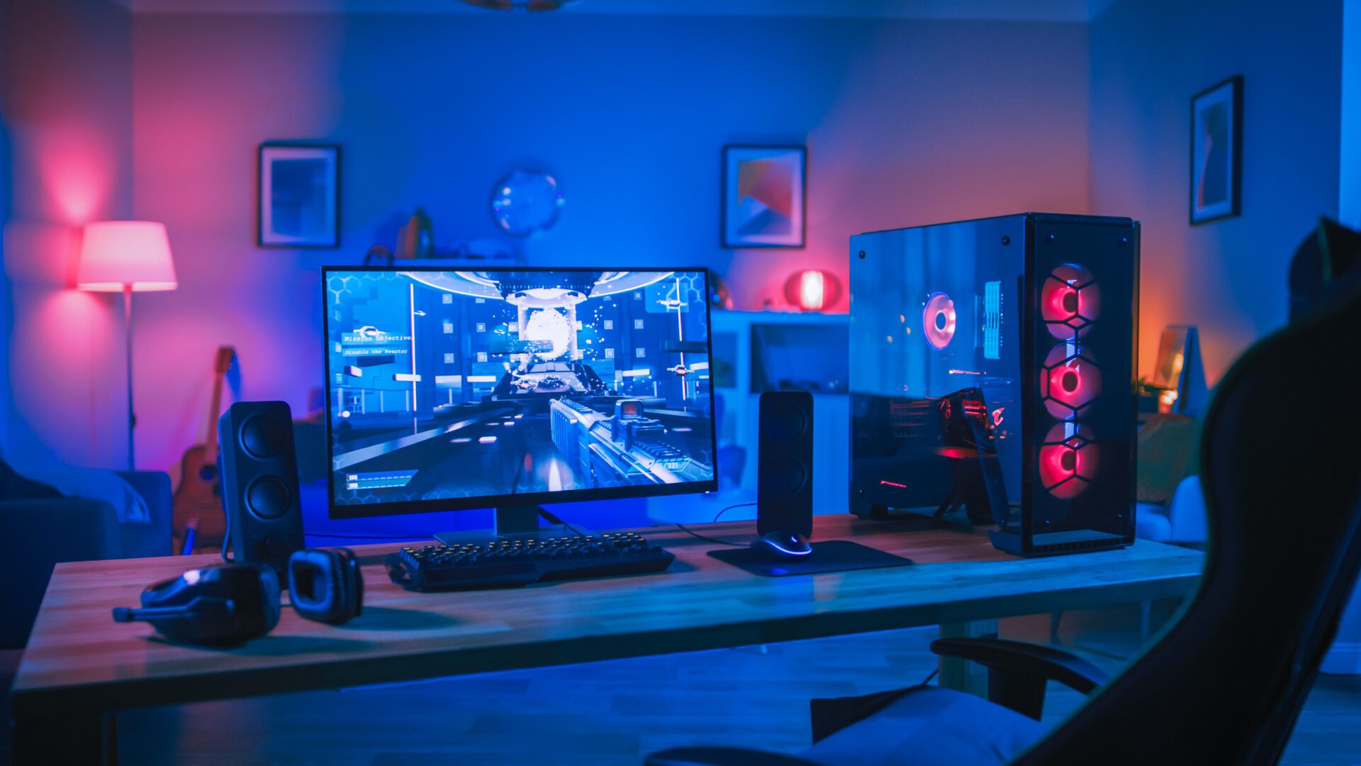 A high-tech gaming setup with colorful RGB lighting and a futuristic cityscape on the monitor.