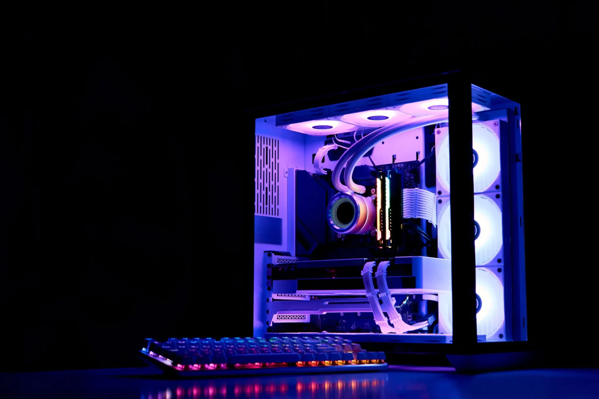 A glowing gaming PC with RGB lighting inside a transparent case.